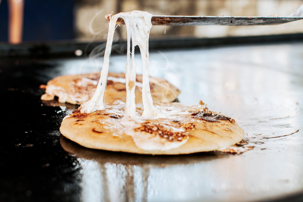 Traditional grilled cheese pupusas, Close up of traditional hand